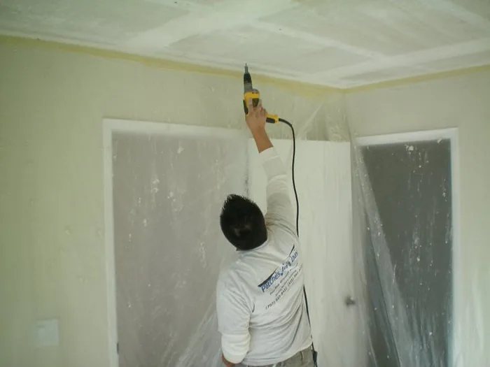 Cracked wall and ceiling assessed for repair