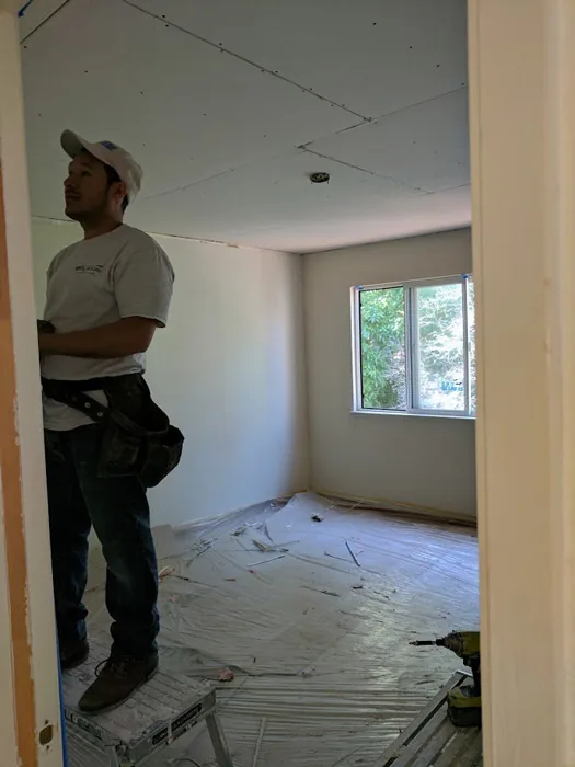 Crew repairing drywall in a rental unit